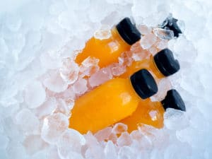 orange juice bottles in ice